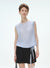 Woman wearing a light blue sleeveless top and black skirt with a white background